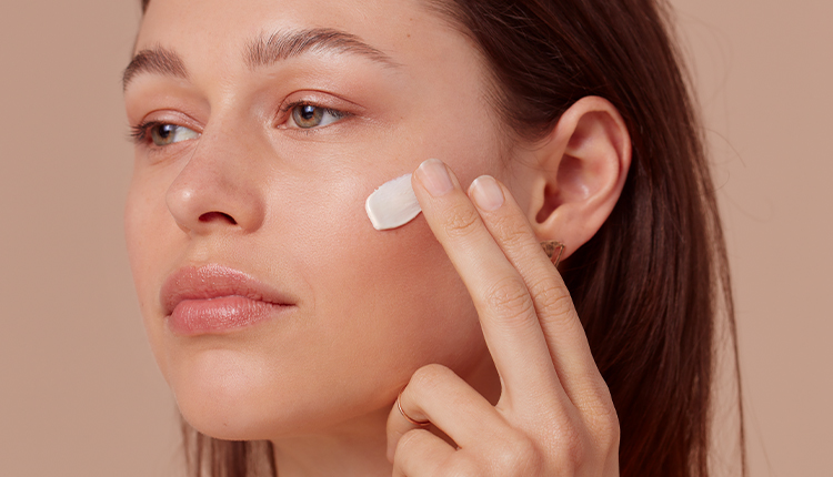 Woman applying face cream